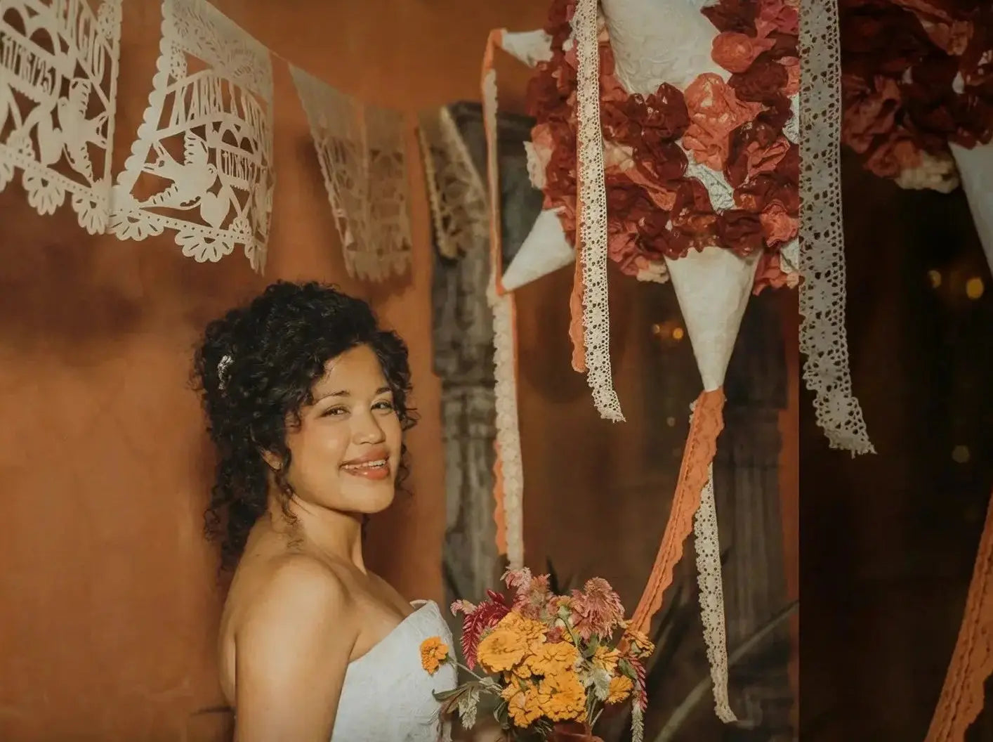 bride with personalized papel picado garlands customized for her wedding