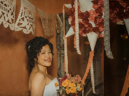bride with personalized papel picado garlands customized for her wedding