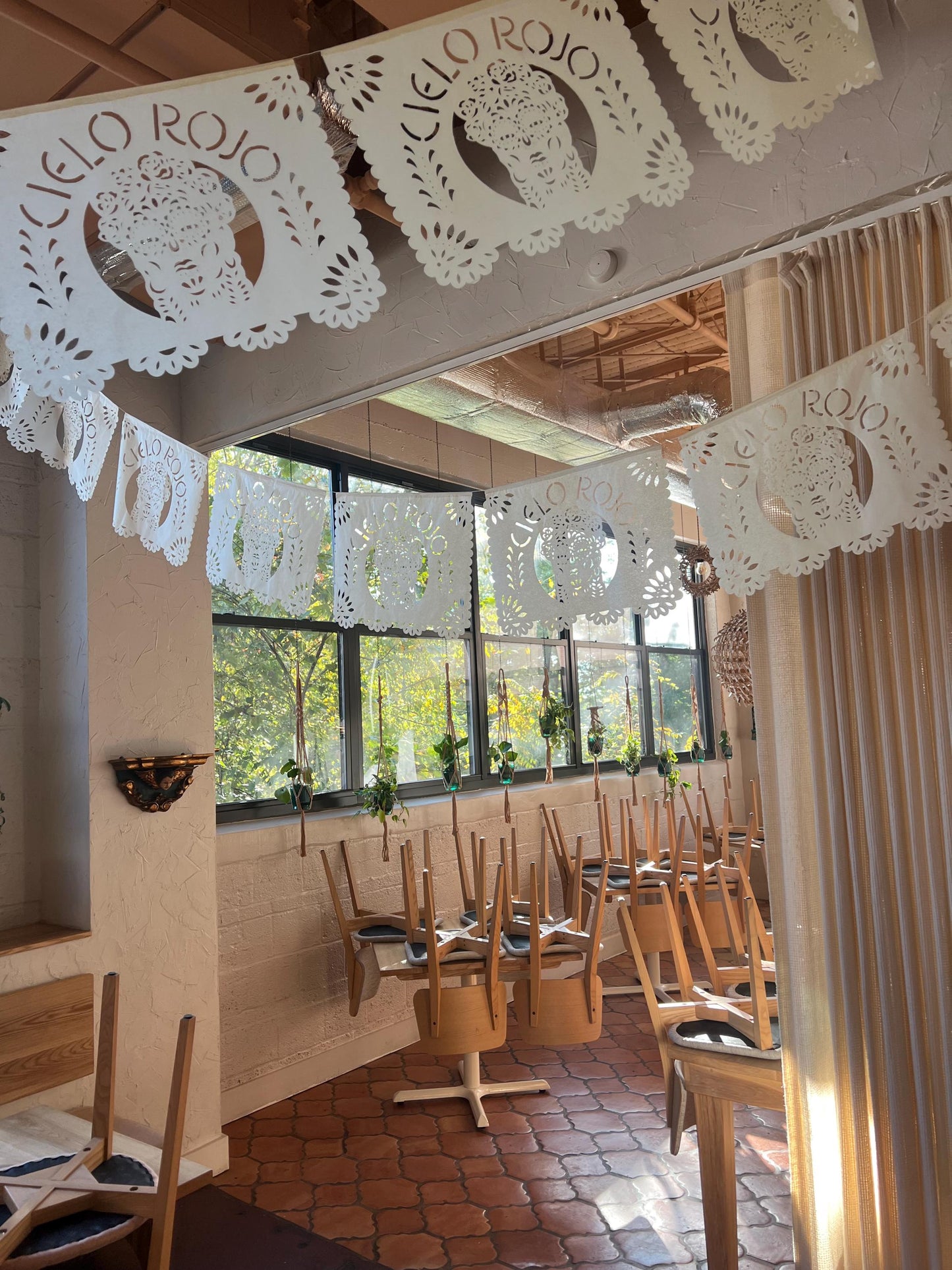 Custom logo papel picado banners hanging in a Mexican restaurant – Fiesta Fancies