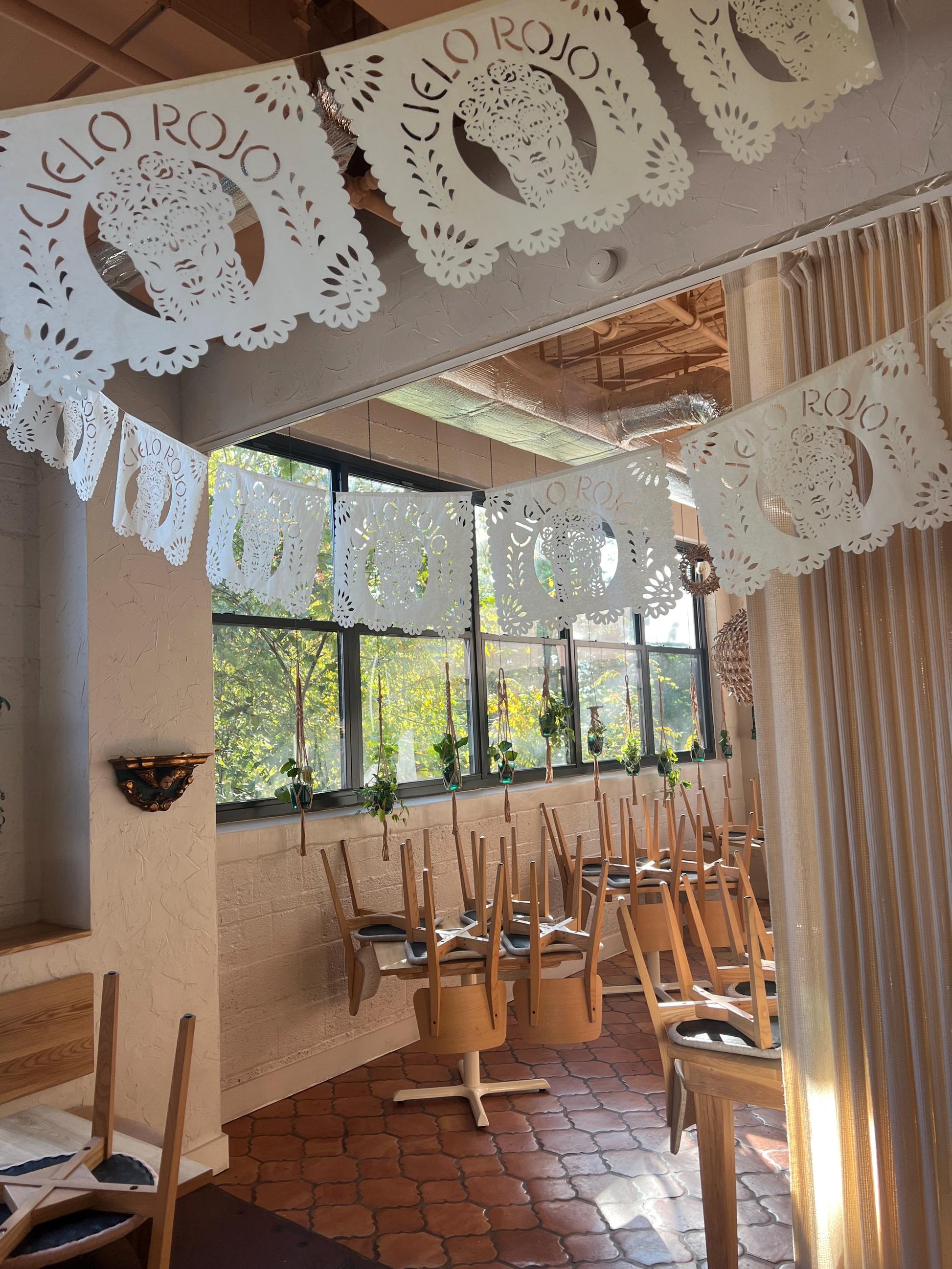 Custom logo papel picado banners hanging in a Mexican restaurant – Fiesta Fancies