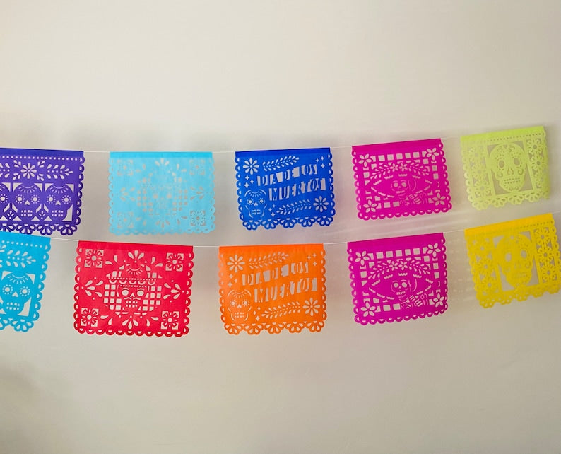 Papel picado panels with Día de los Muertos text