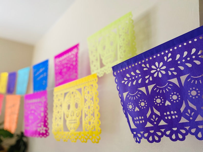 Multicolor papel picado banner with skull and floral designs