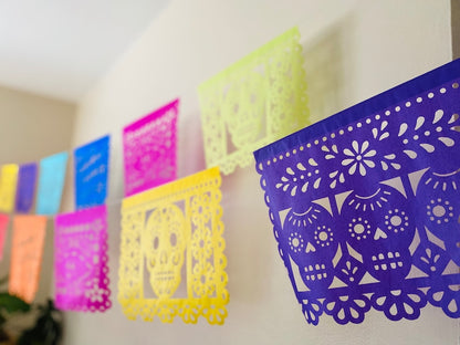 Multicolor papel picado banner with skull and floral designs