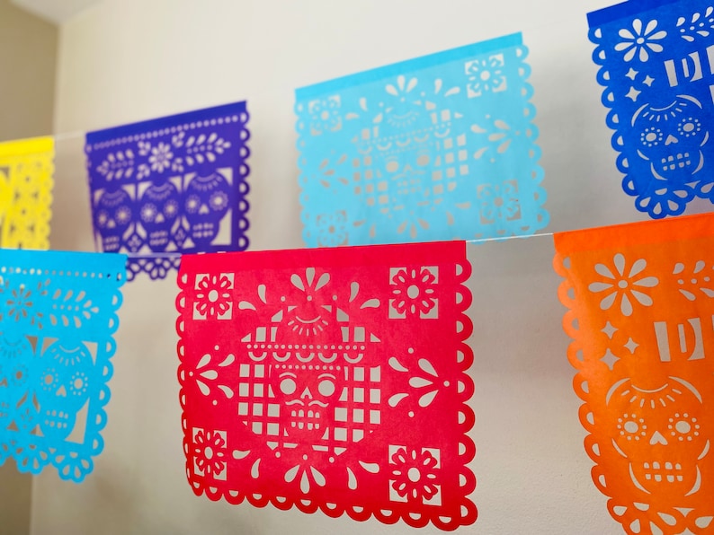 Papel picado banner with skulls, flowers and geometric cutouts