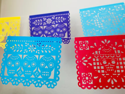 Yellow, blue and red papel picado on white string
