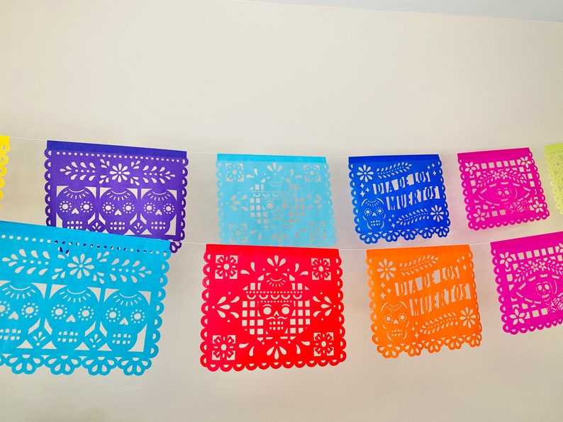 Purple, blue, pink and orange Día de los Muertos papel picado